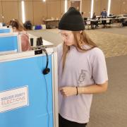 Student voting in person in the UMC Vote Center