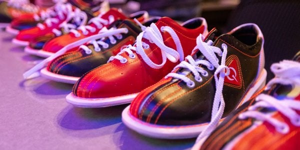 A row of red and black bowling shoes